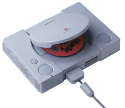 An original PlayStation console with a disc inside it.